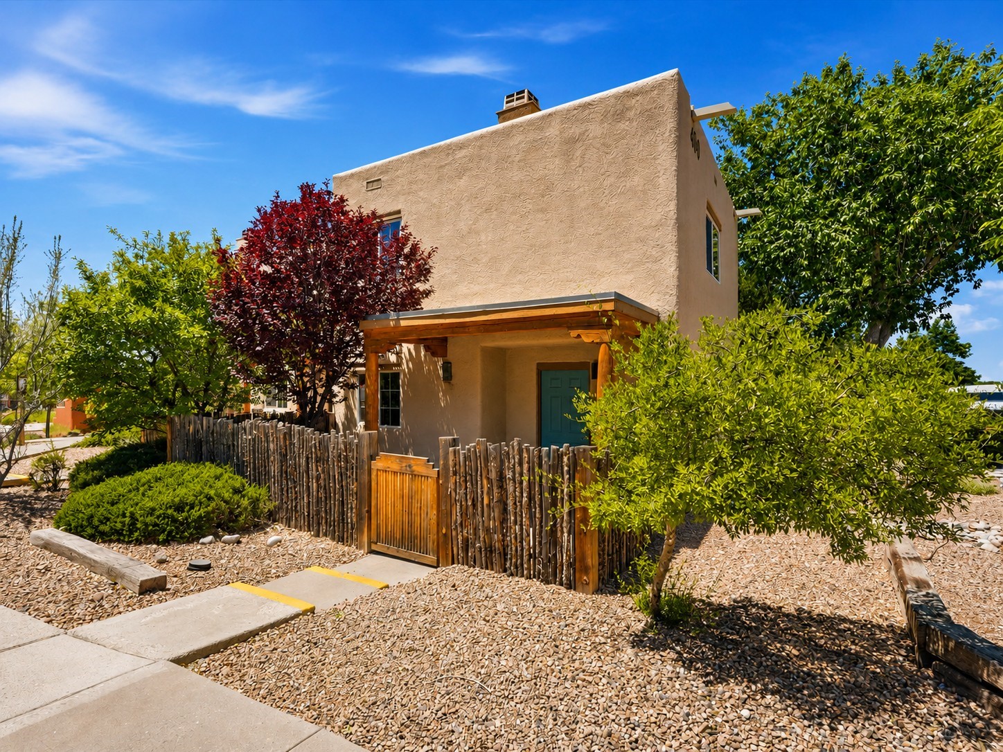 2210 Miguel Chavez Road, Unit 411 Santa Fe, NM 87505 - Photo 2 of 59 Facade of the unit with coyote fence for privacy
