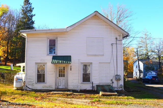 a view of a brick house with large windows