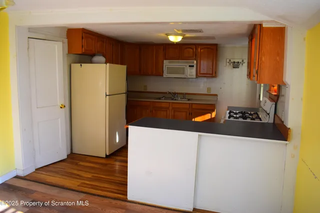 a kitchen with a refrigerator and a stove