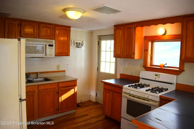 a kitchen with granite countertop a stove and a sink
