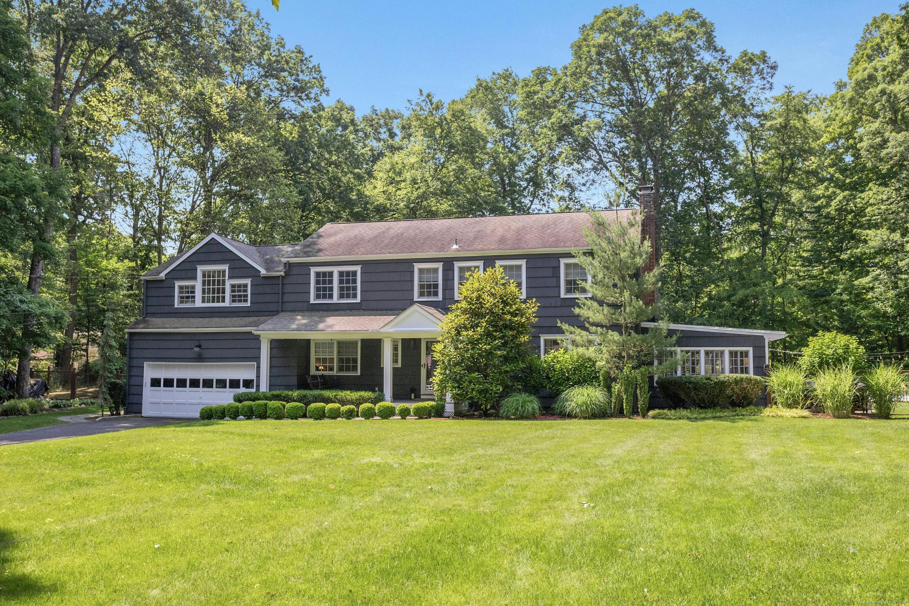 21 Roxbury Lane Wilton, CT 06897 - Photo 2 of 37 On a classic, small group cul-de-sac, the smallest distance from Wilton Town Center.