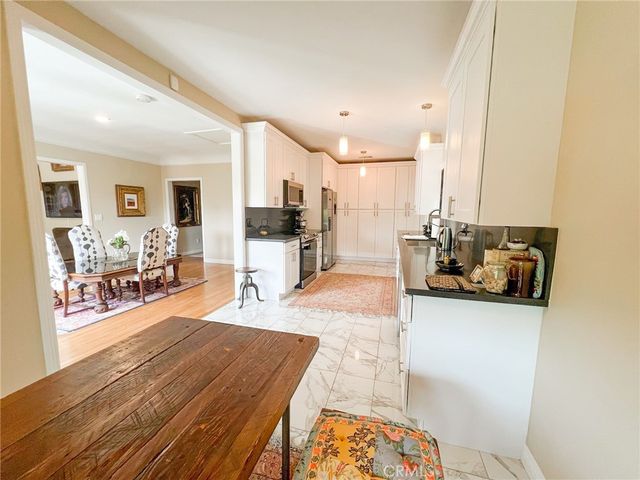 a bedroom with a bed and a mirror on the dresser