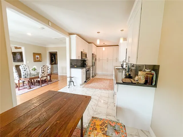 a bedroom with a bed and a mirror on the dresser
