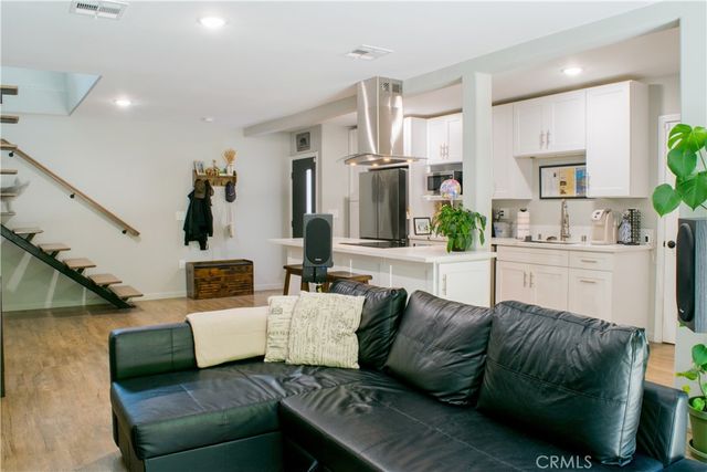 a view of a room that has a bed mirror and a dining table
