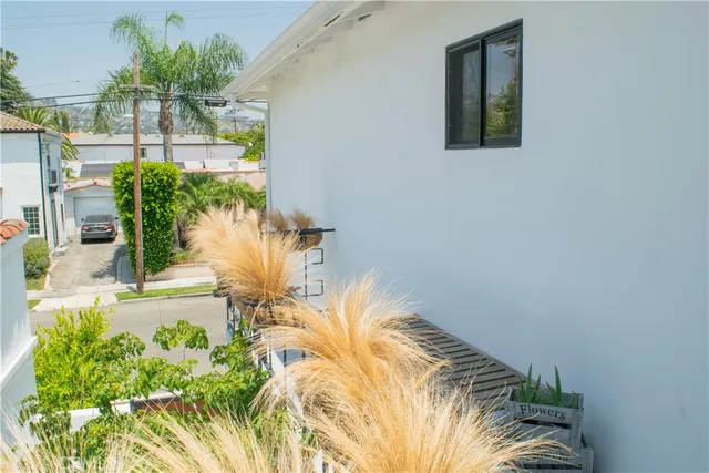 a view of a patio with couches table and chairs and potted plants