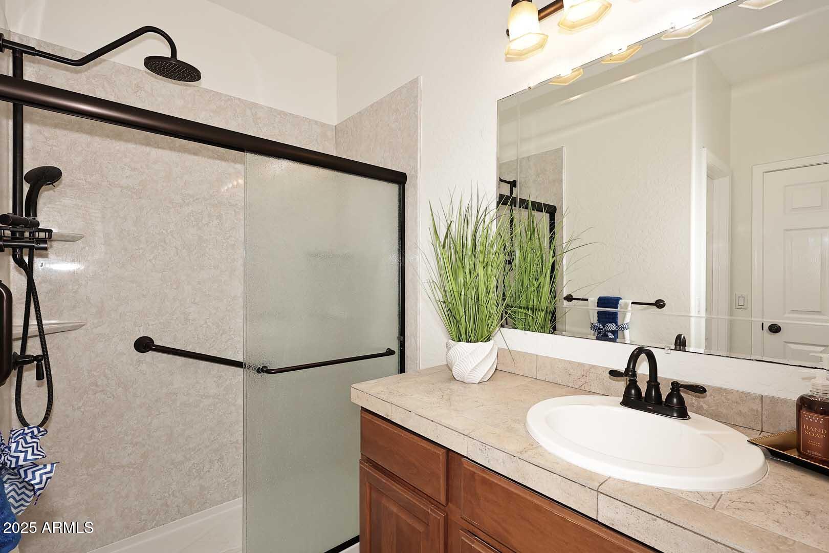 3644 North 15th Street Phoenix, AZ 85014 - Photo 11 of 26 a bathroom with a granite countertop sink and a mirror