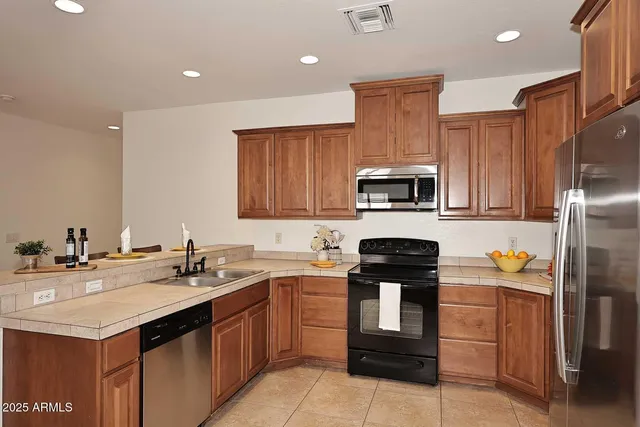 a kitchen with a sink stove and refrigerator
