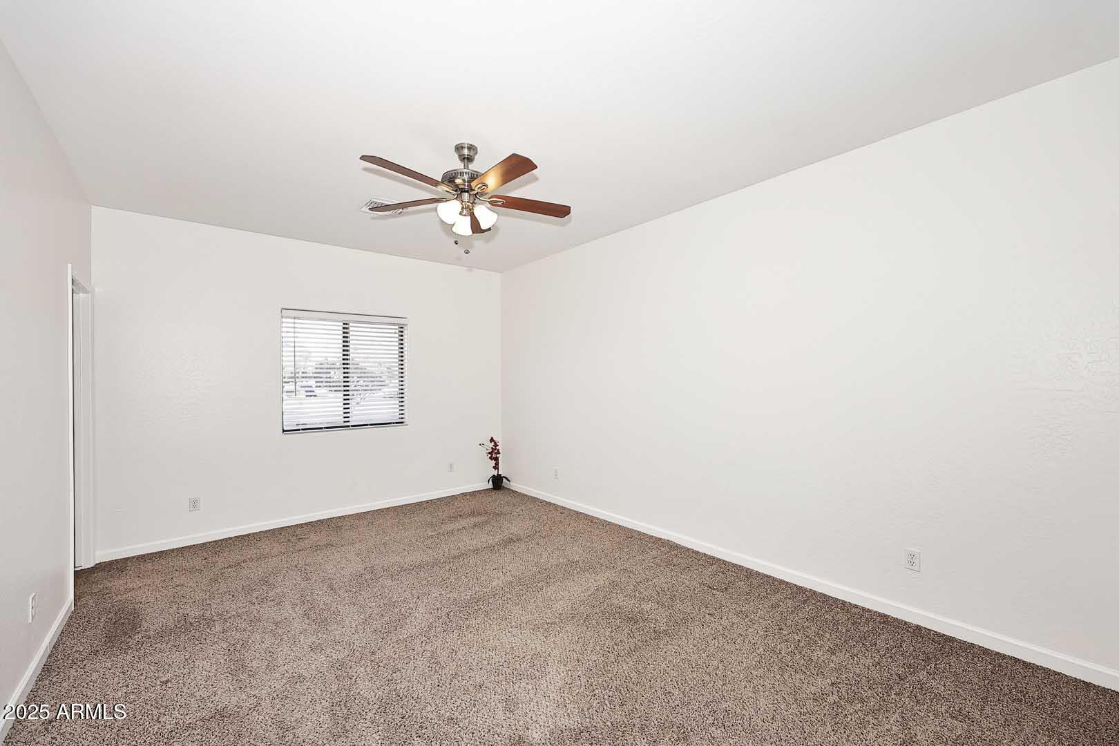 3644 North 15th Street Phoenix, AZ 85014 - Photo 9 of 26 an empty room with a window and a fan