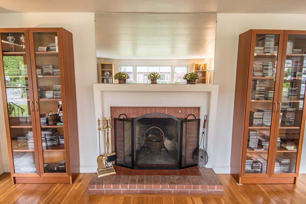 79 Park Street Dedham, MA 02026 - Photo 12 of 29 a living room with a fireplace and a wooden floor