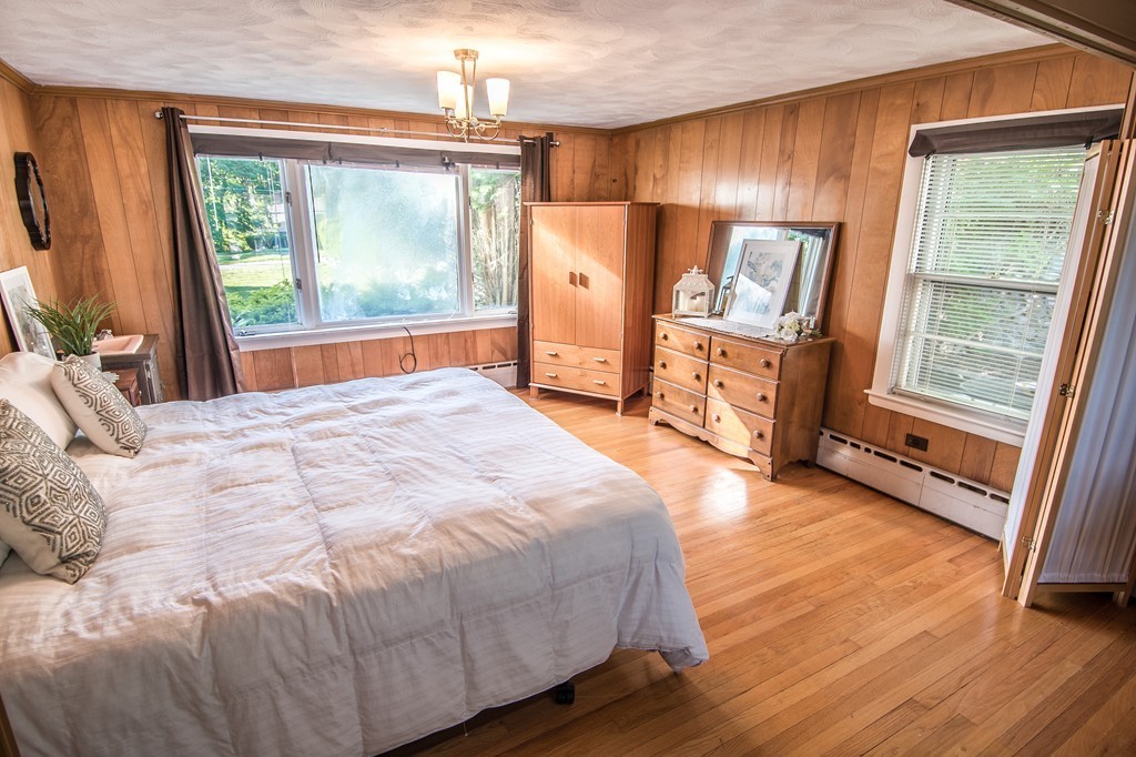 79 Park Street Dedham, MA 02026 - Photo 17 of 29 a large bed sitting in a room next to a window