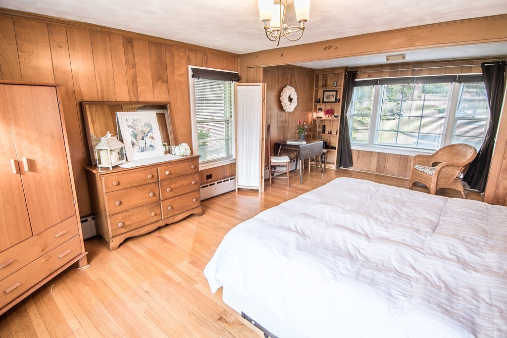 79 Park Street Dedham, MA 02026 - Photo 19 of 29 a bed room with a bed and a chair
