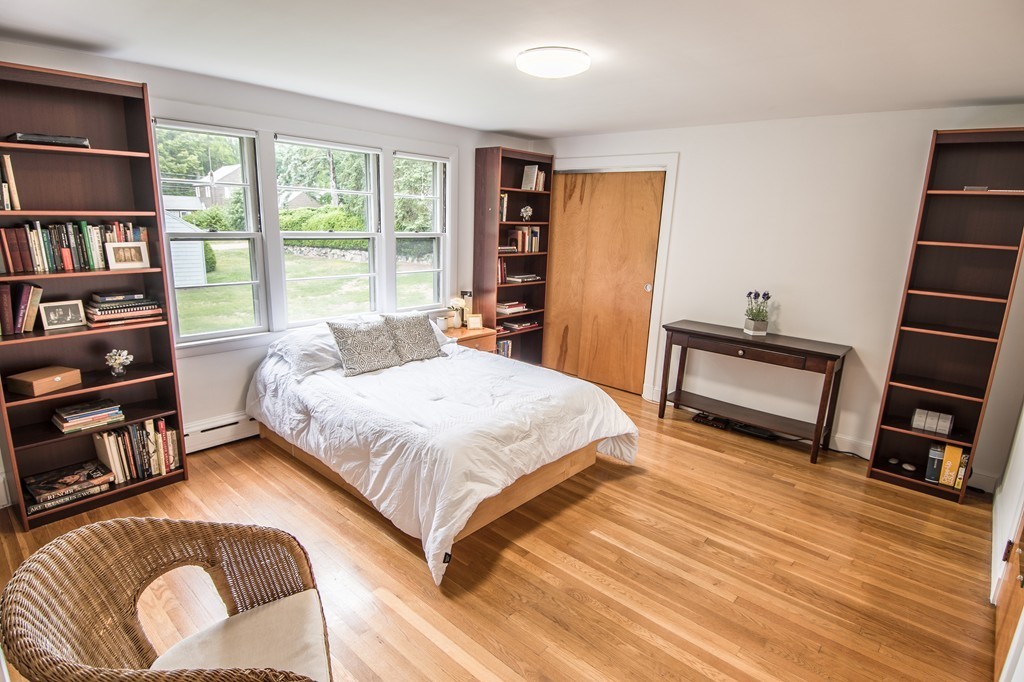 79 Park Street Dedham, MA 02026 - Photo 21 of 29 a bedroom with a bed a couch and a book shelf