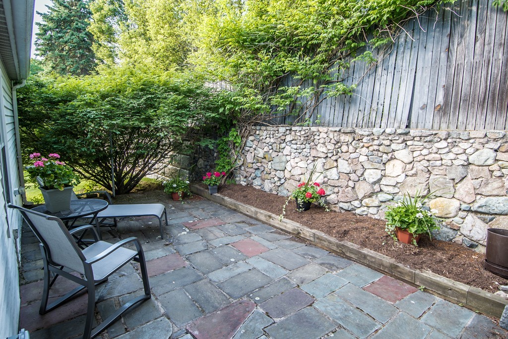 79 Park Street Dedham, MA 02026 - Photo 25 of 29 a wooden bench with some trees