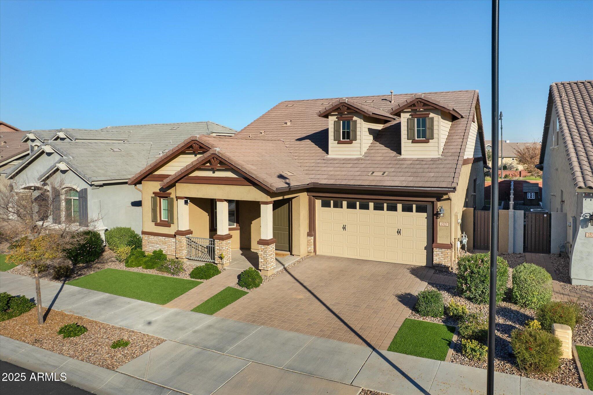 2527 South Quaintance Street Gilbert, AZ 85295 - Photo 1 of 36 a front view of a house with a garden