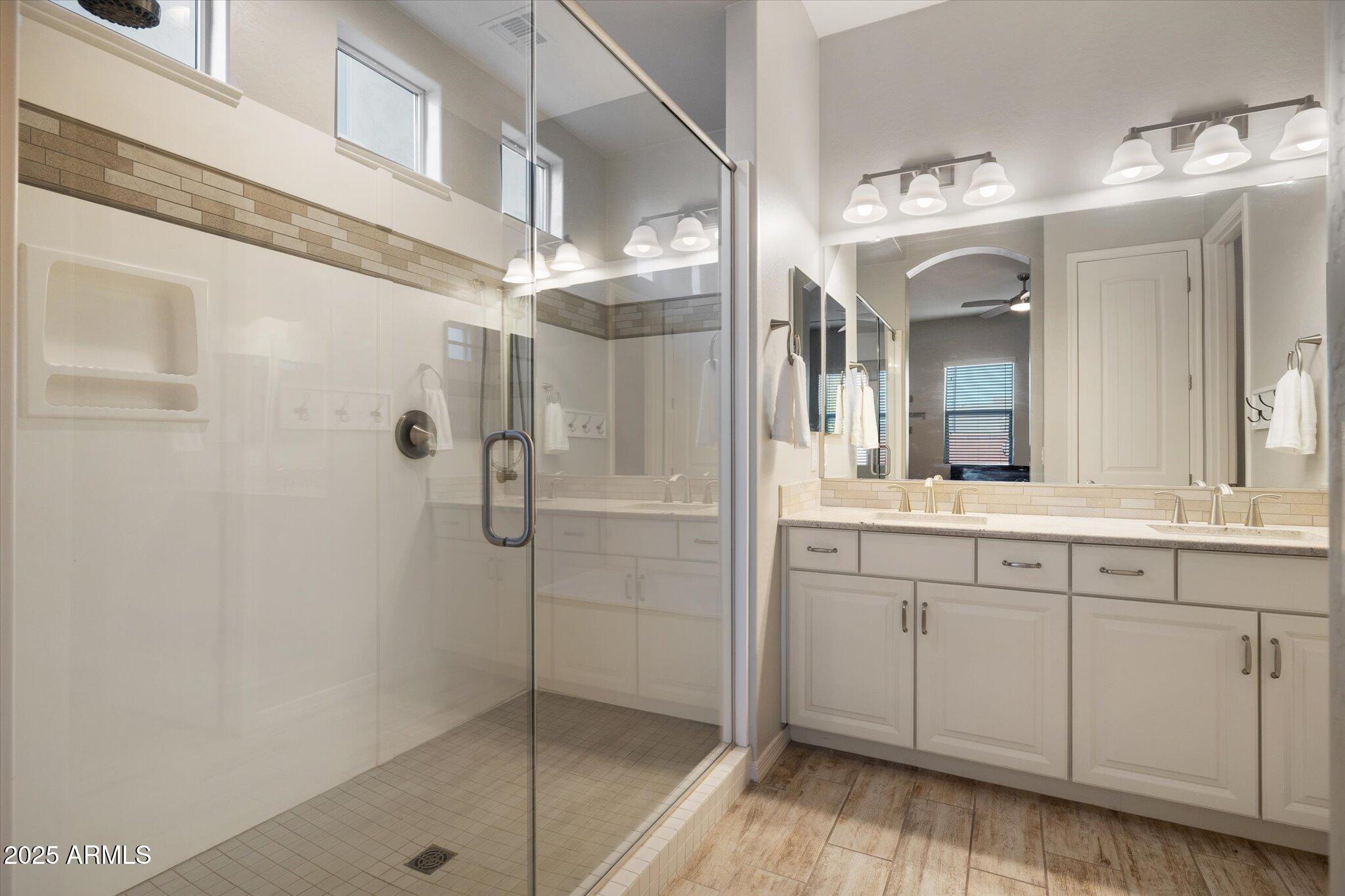 2527 South Quaintance Street Gilbert, AZ 85295 - Photo 12 of 36 a bathroom with a shower a sink and a mirror