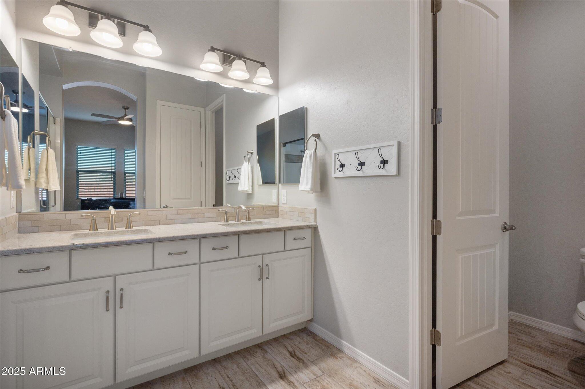 2527 South Quaintance Street Gilbert, AZ 85295 - Photo 13 of 36 a bathroom with a double vanity sink and mirror