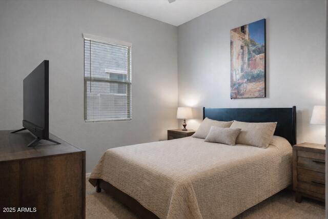 2527 South Quaintance Street Gilbert, AZ 85295 - Photo 14 of 36 a bedroom with a large bed and a flat tv screen on a dresser