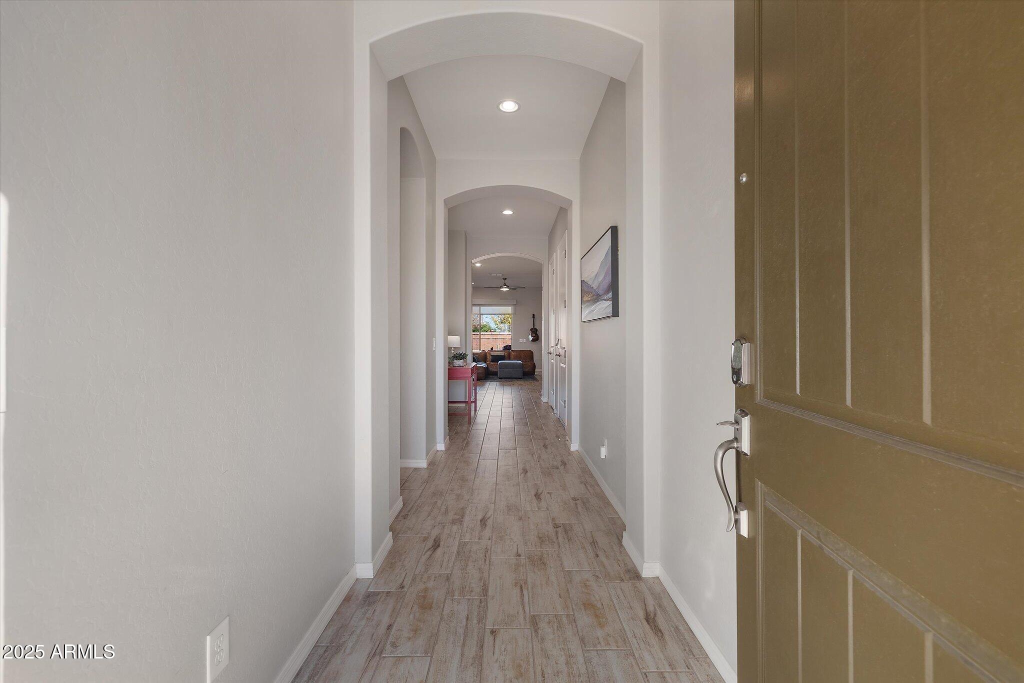 2527 South Quaintance Street Gilbert, AZ 85295 - Photo 23 of 36 a view of a hallway with wooden floor and a bathroom