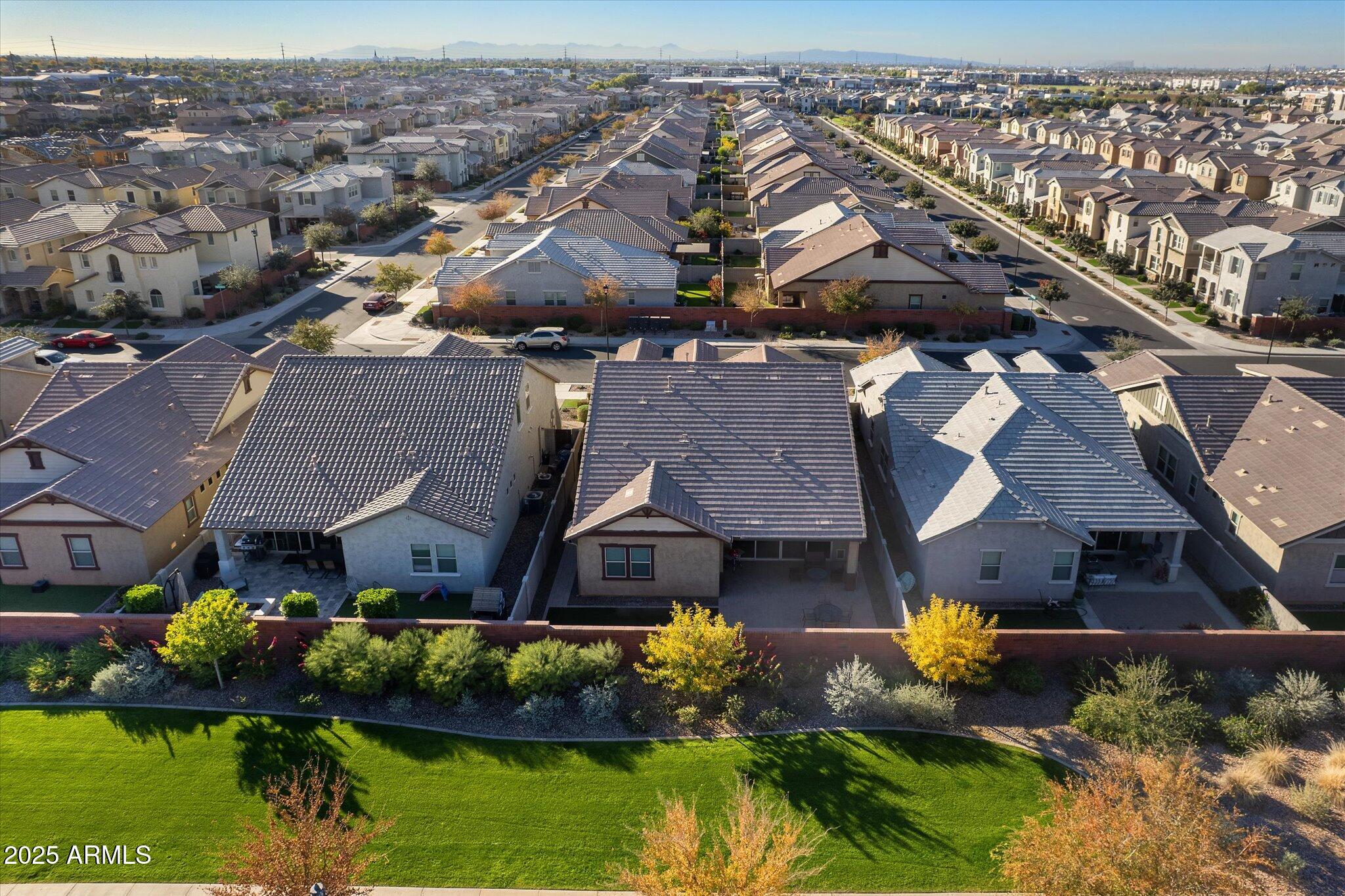 2527 South Quaintance Street Gilbert, AZ 85295 - Photo 24 of 36 an aerial view of a house with a garden and lake view
