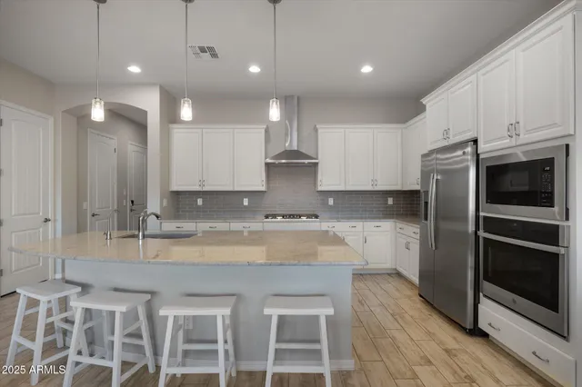 a kitchen with a sink refrigerator and cabinets