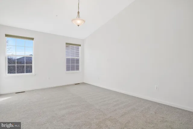 a bathroom with a granite countertop sink mirror and a bathtub next to a window