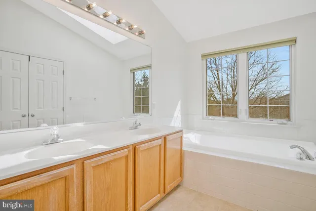 a bathroom with a granite countertop sink a toilet and a bathtub
