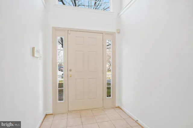 an empty room with a fireplace and window