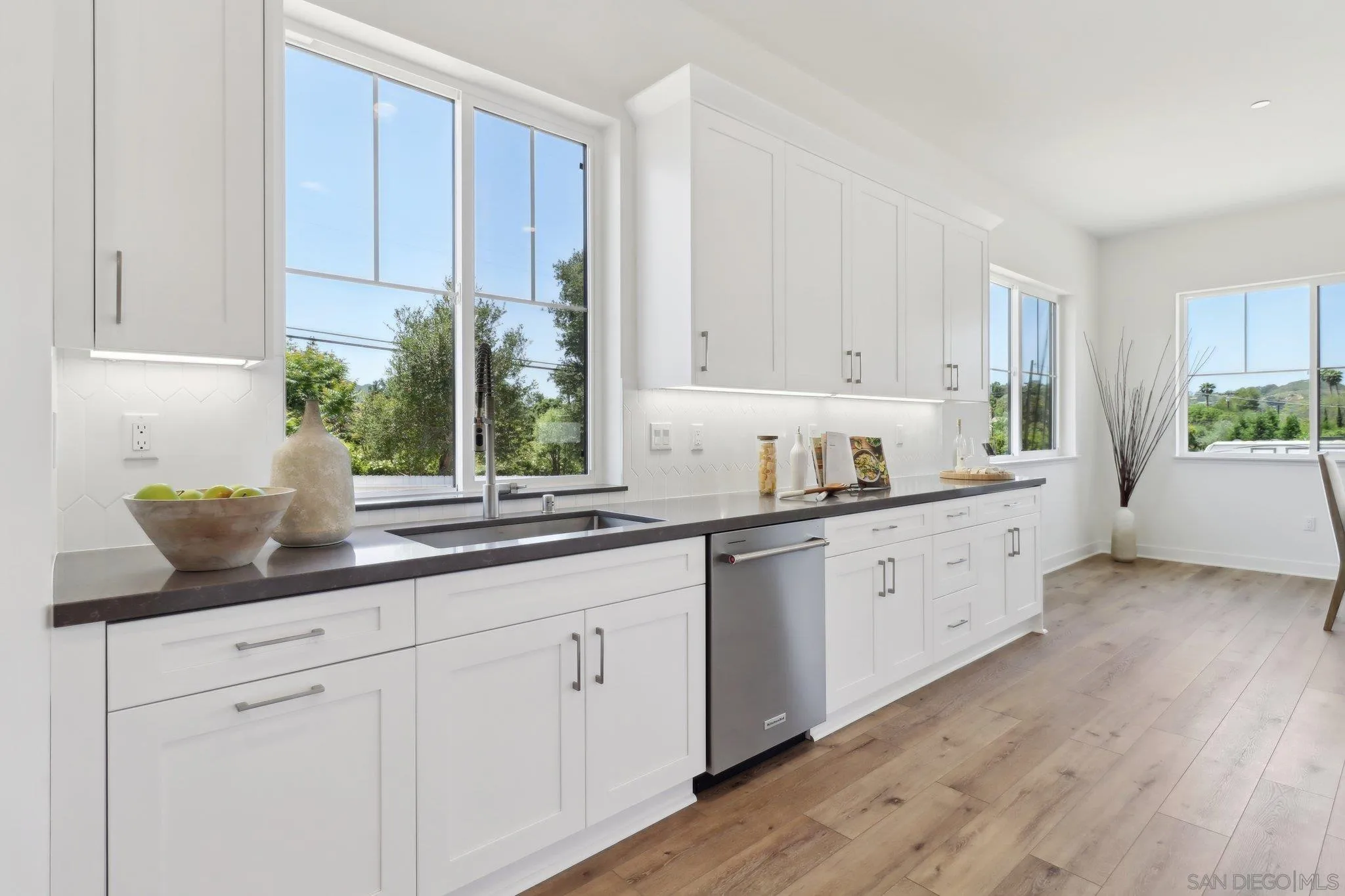 2745 Alexander Drive Escondido, CA 92029 - Photo 11 of 39 a kitchen with granite countertop white cabinets and white appliances