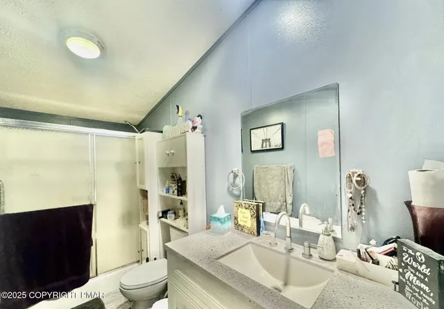 a living room with furniture a rug and a toilet