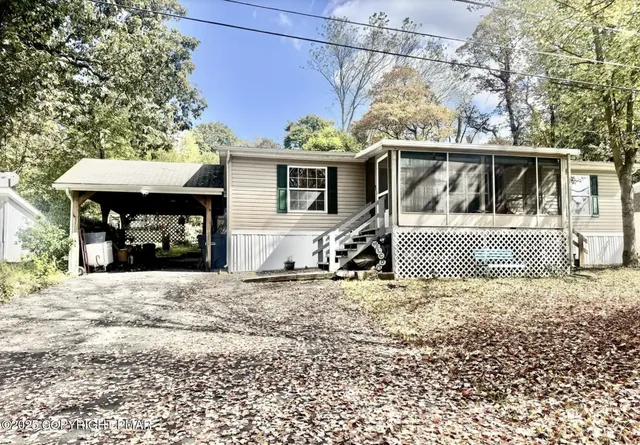 a view of a house with a tree in a yard