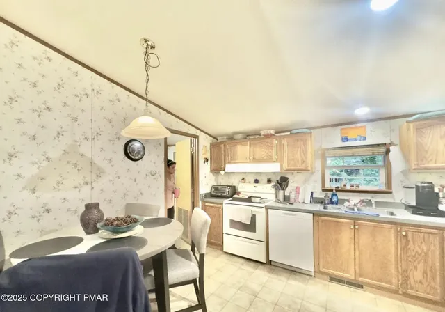 a kitchen with stainless steel appliances kitchen island granite countertop a sink and cabinets