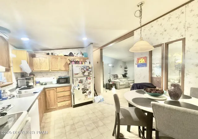 a kitchen with stainless steel appliances kitchen island granite countertop a sink and cabinets