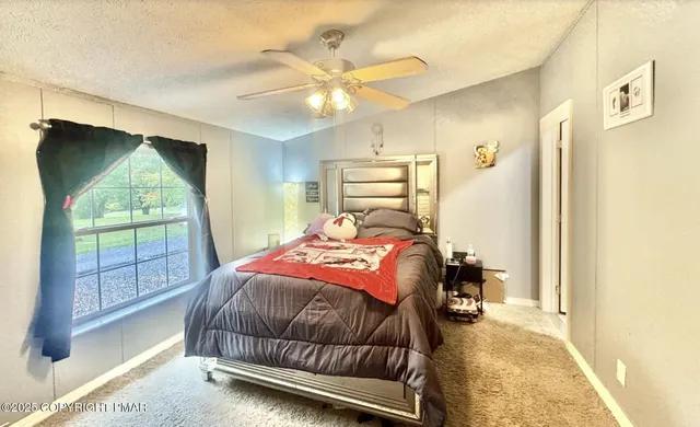 a bedroom with a bed and window