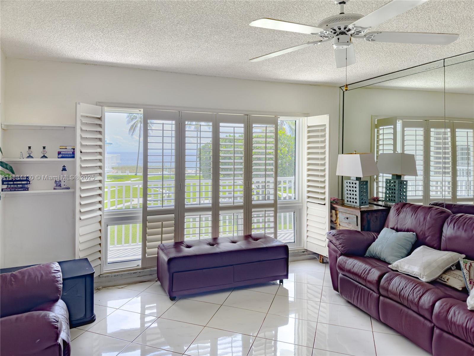 1470 South Ocean Boulevard, Unit 702 Pompano Beach, FL 33062 - Photo 2 of 15 a living room with furniture and a large window