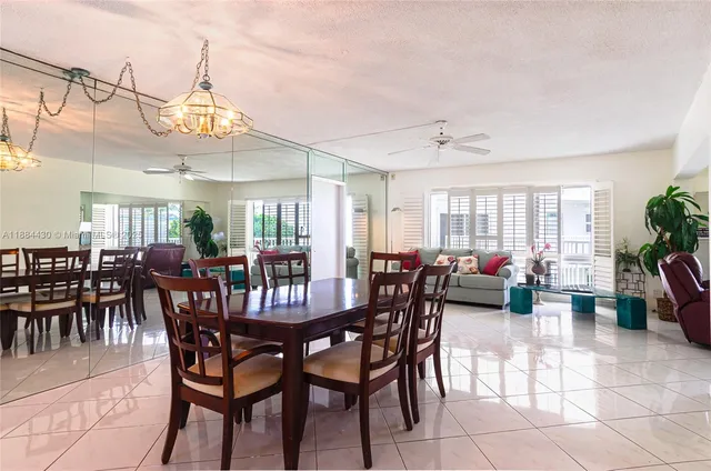 a view of a dining room with furniture and a chandelier