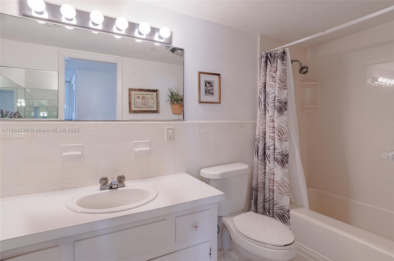 1470 South Ocean Boulevard, Unit 702 Pompano Beach, FL 33062 - Photo 10 of 15 a bathroom with a sink a toilet a mirror a vanity and shower