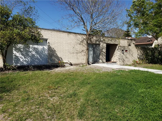 a view of a garden with large trees
