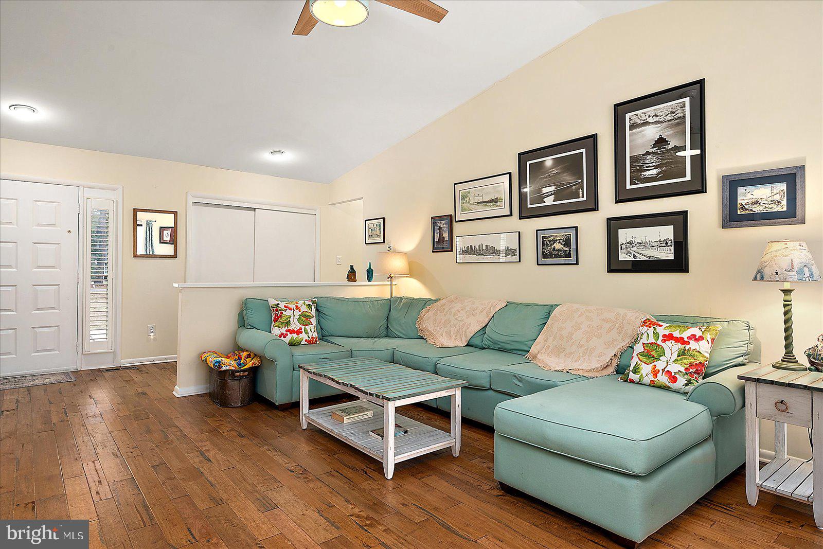 21 Drawbridge Road Ocean Pines, MD 21811 - Photo 7 of 103 a living room with furniture and paintings on the wall next to a window