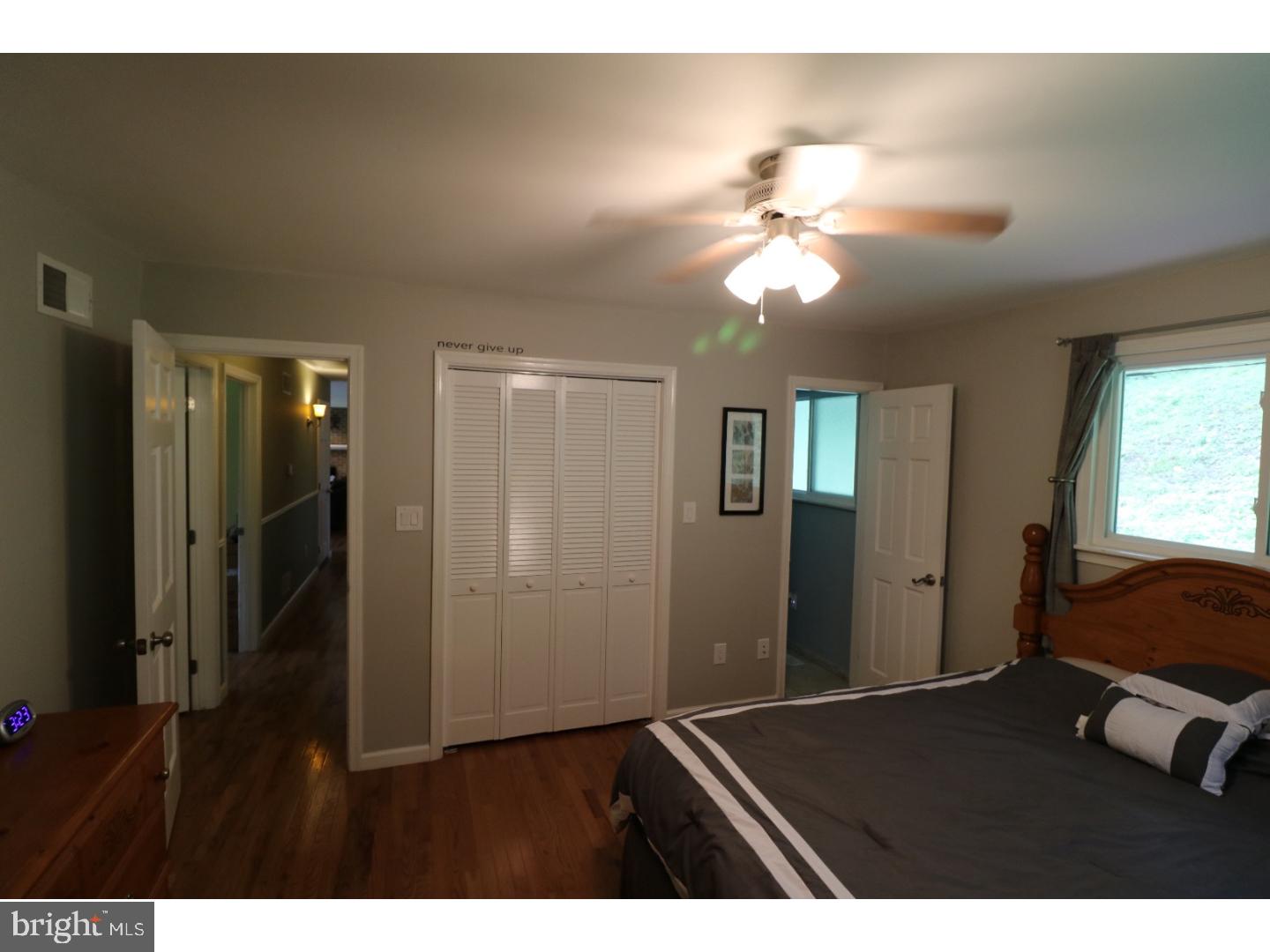 2571 Welsh Road Mohnton, PA 19540 - Photo 16 of 23 a bedroom with a bed and a chandelier