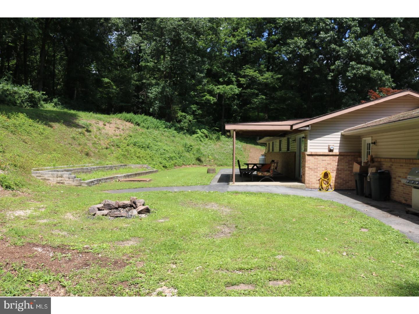 2571 Welsh Road Mohnton, PA 19540 - Photo 20 of 23 a view of a backyard with hardwood area and garden