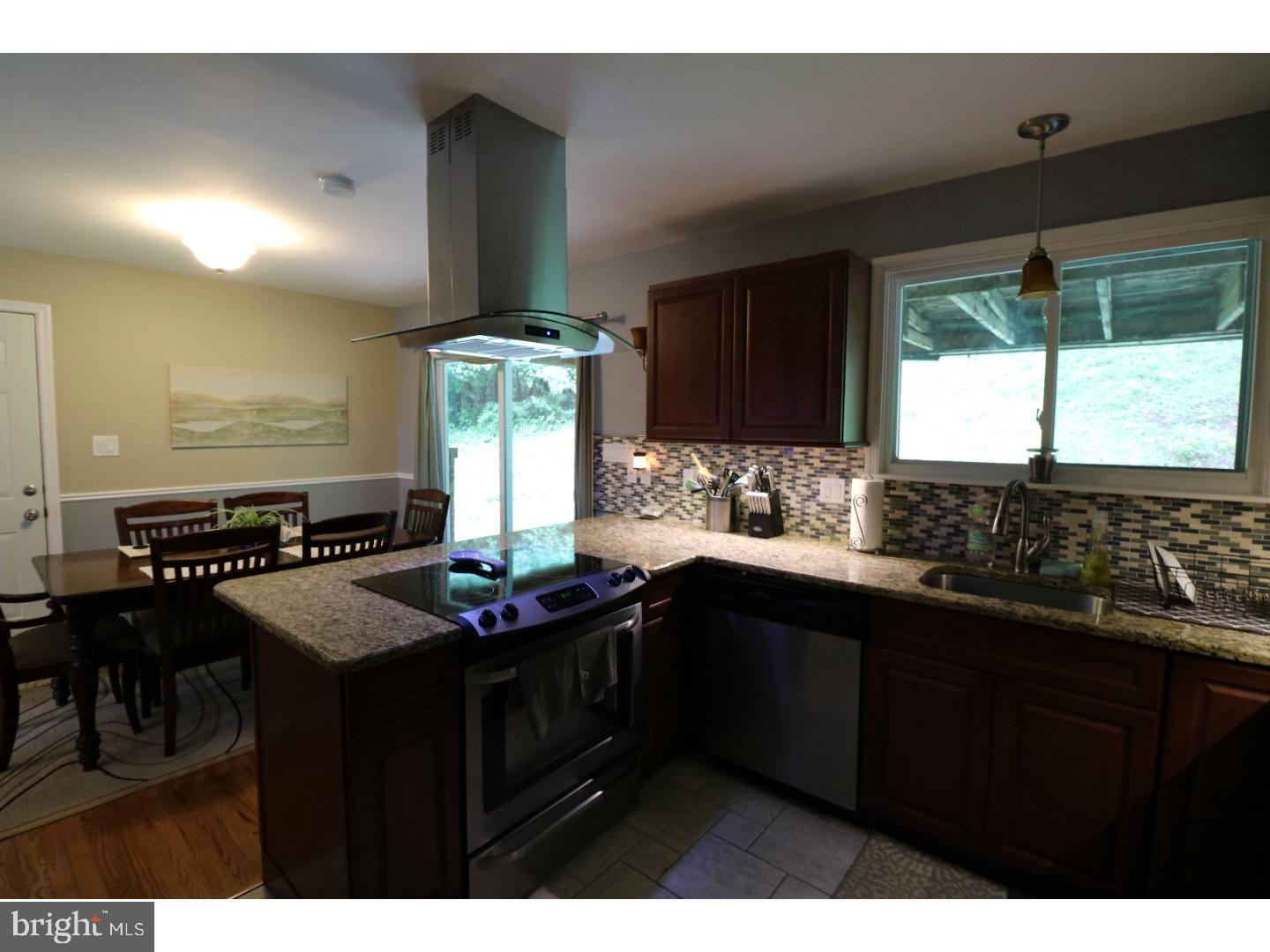 2571 Welsh Road Mohnton, PA 19540 - Photo 7 of 23 a kitchen with kitchen island granite countertop a sink appliances cabinets and a counter top space