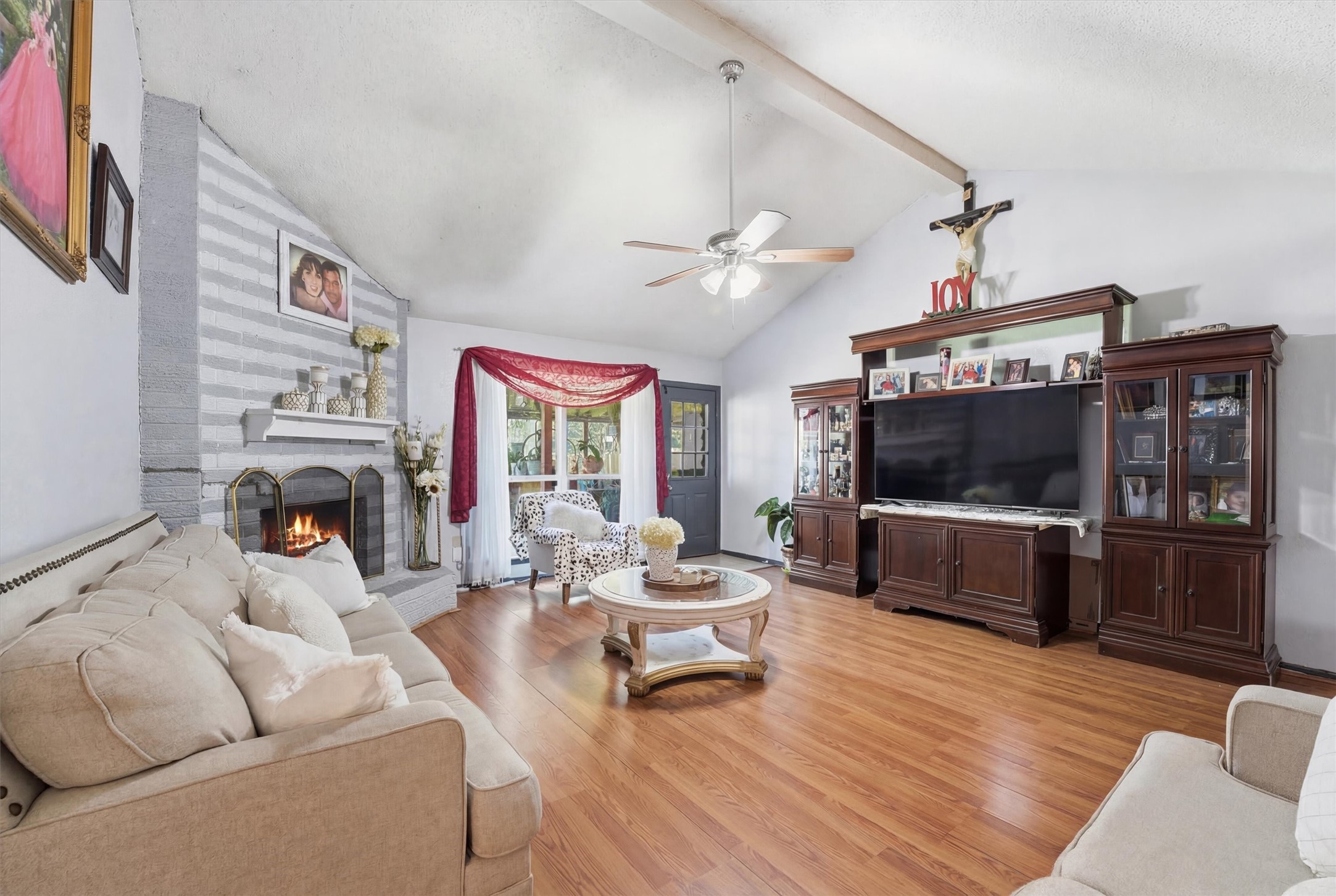 6203 Sunnygate Drive Spring, TX 77373 - Photo 20 of 23 a living room with furniture a fireplace and a flat screen tv