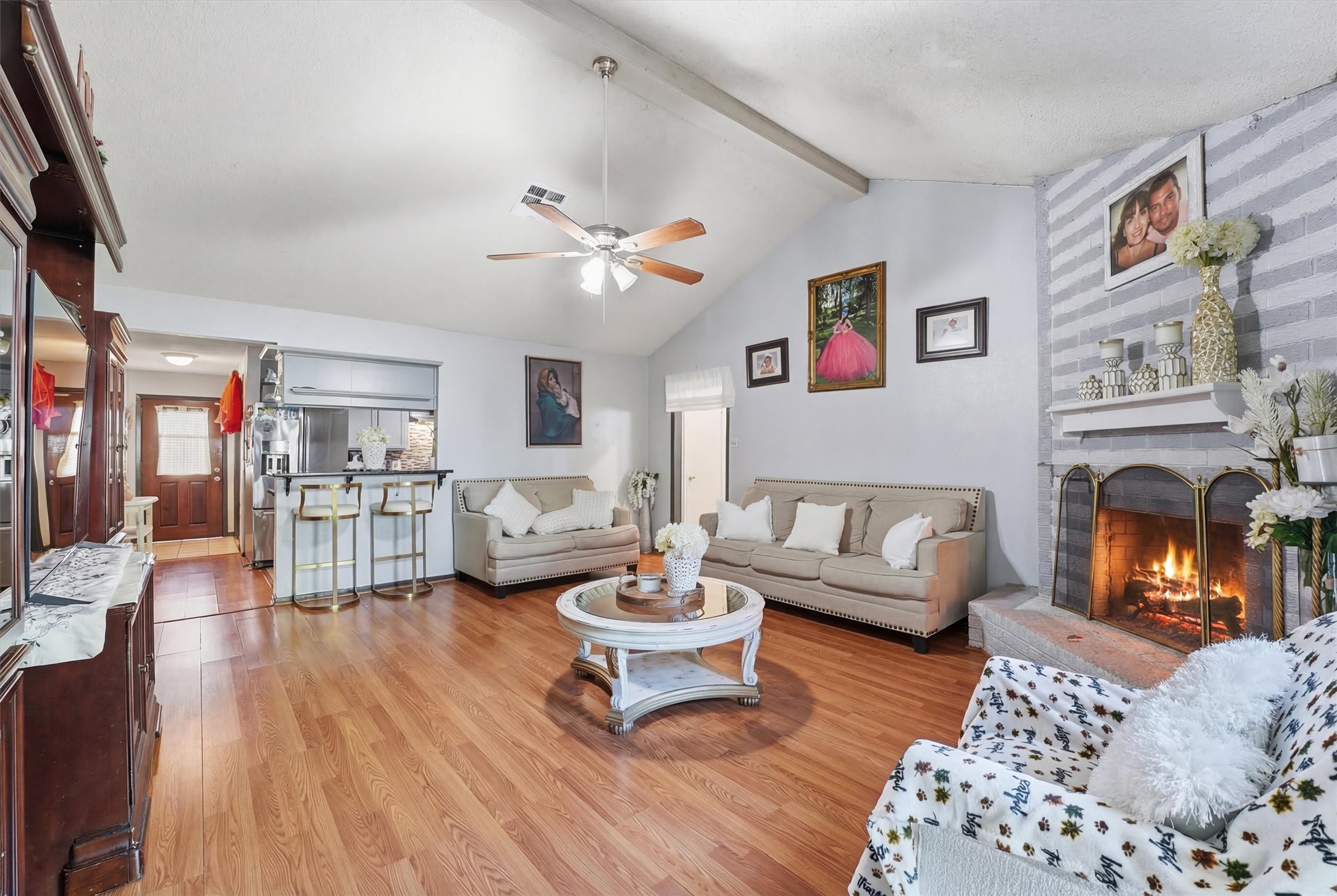 6203 Sunnygate Drive Spring, TX 77373 - Photo 21 of 23 a living room with furniture a fireplace and a flat screen tv