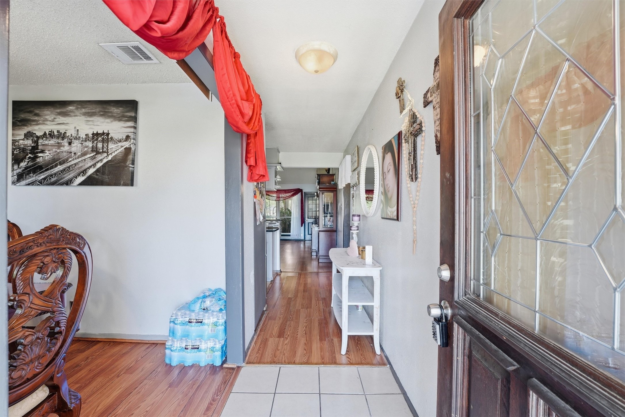 6203 Sunnygate Drive Spring, TX 77373 - Photo 4 of 23 a view of a hallway with wooden floor and a dining space