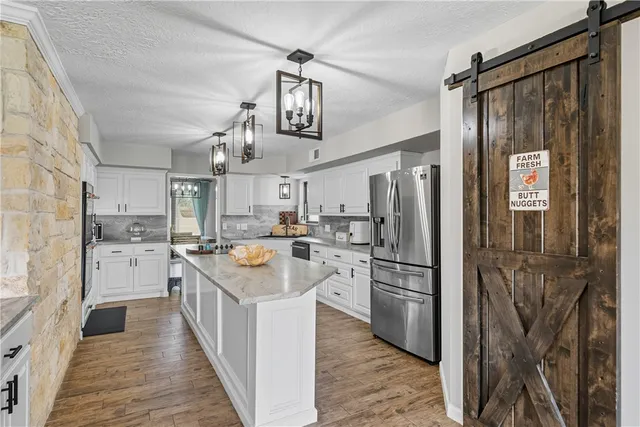 a kitchen with white cabinets and sink