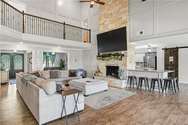 a bedroom with furniture and a large window
