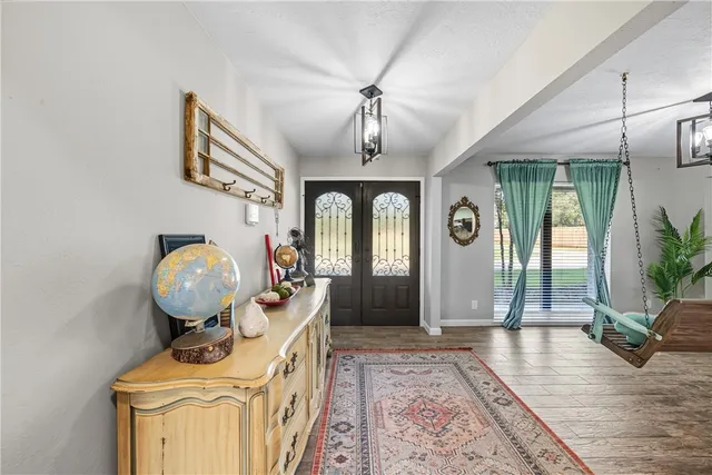 a view of a dining room with furniture and a chandelier