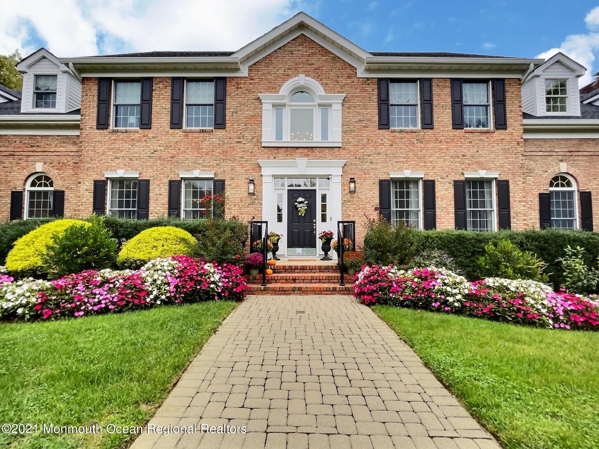 21 Dearborn Drive Holmdel, NJ 07733 - Photo 1 of 48 a front view of house and yard with beautiful flowers