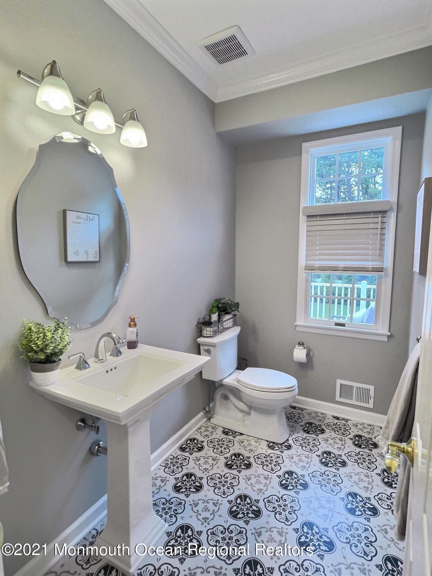 21 Dearborn Drive Holmdel, NJ 07733 - Photo 12 of 48 a bathroom with a toilet a sink and a mirror