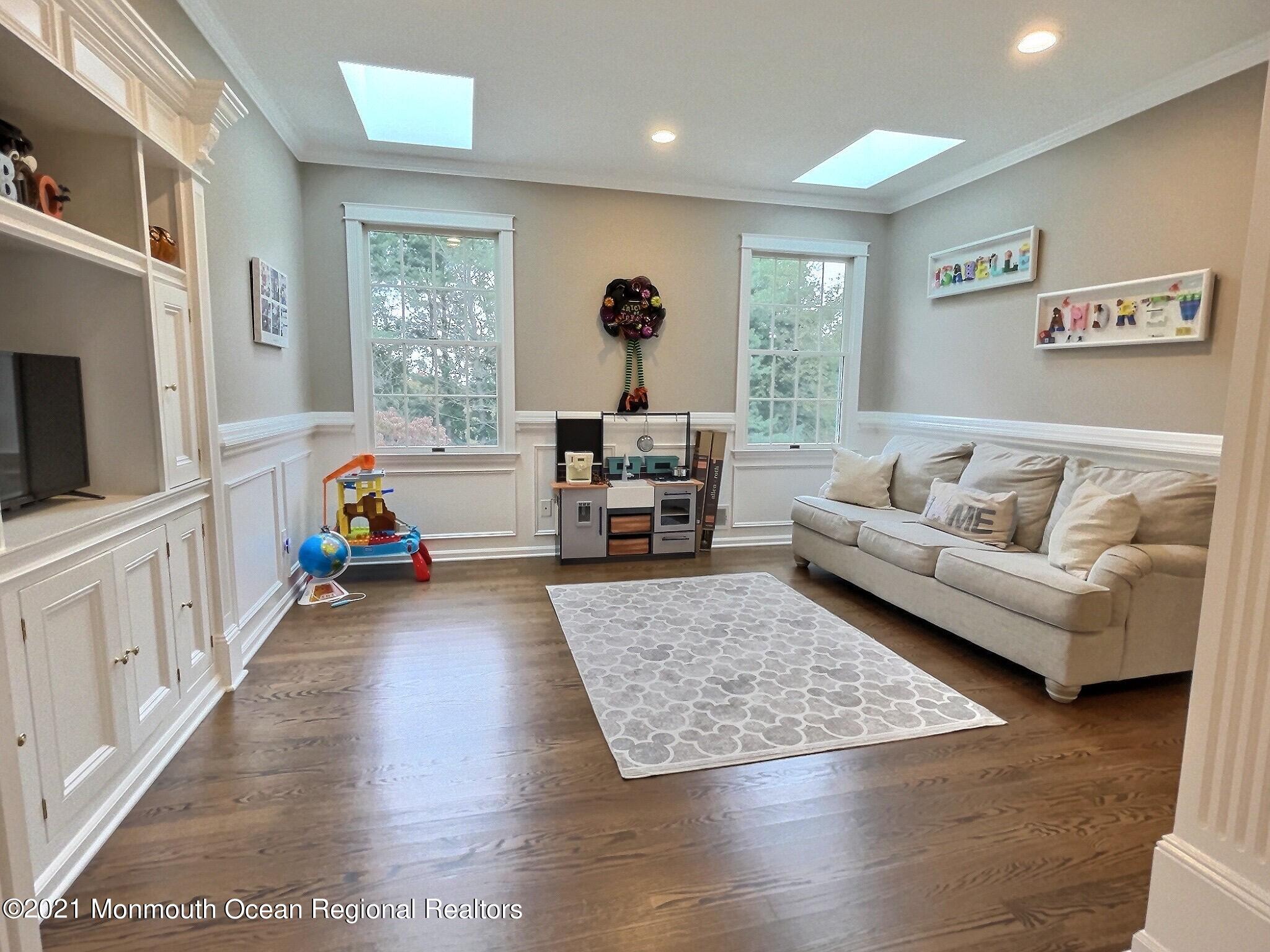 21 Dearborn Drive Holmdel, NJ 07733 - Photo 21 of 48 a living room with furniture and a flat screen tv